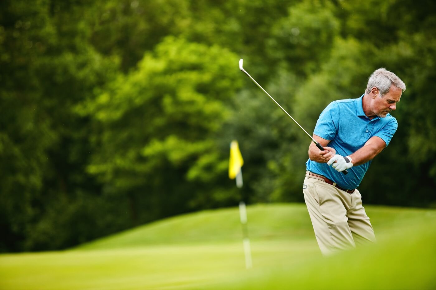 Retired business owner golfing